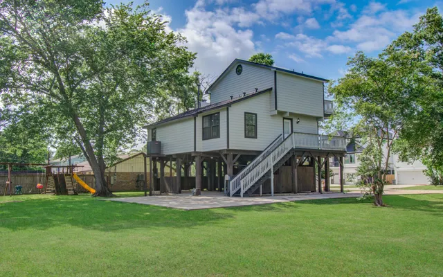 a view of a house with a big yard and sitting area