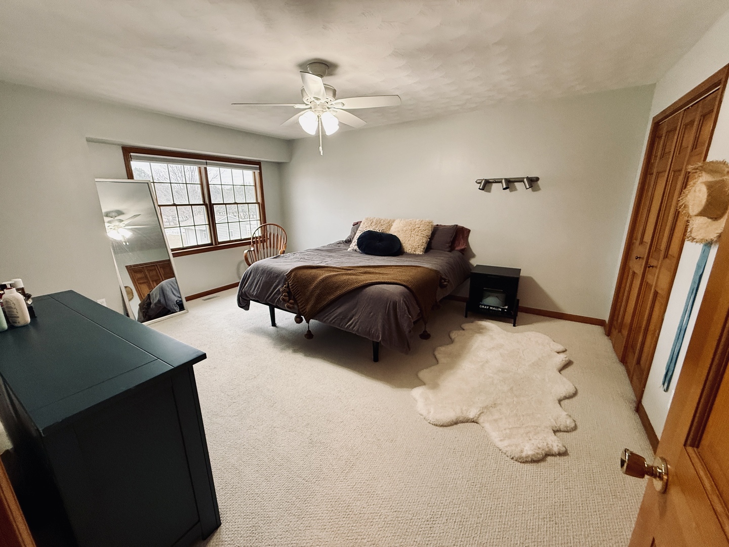 10151 East Hickory Ridge Drive Rochelle, IL 61068 - Photo 14 of 31 a spacious bedroom with a bed and a chandelier