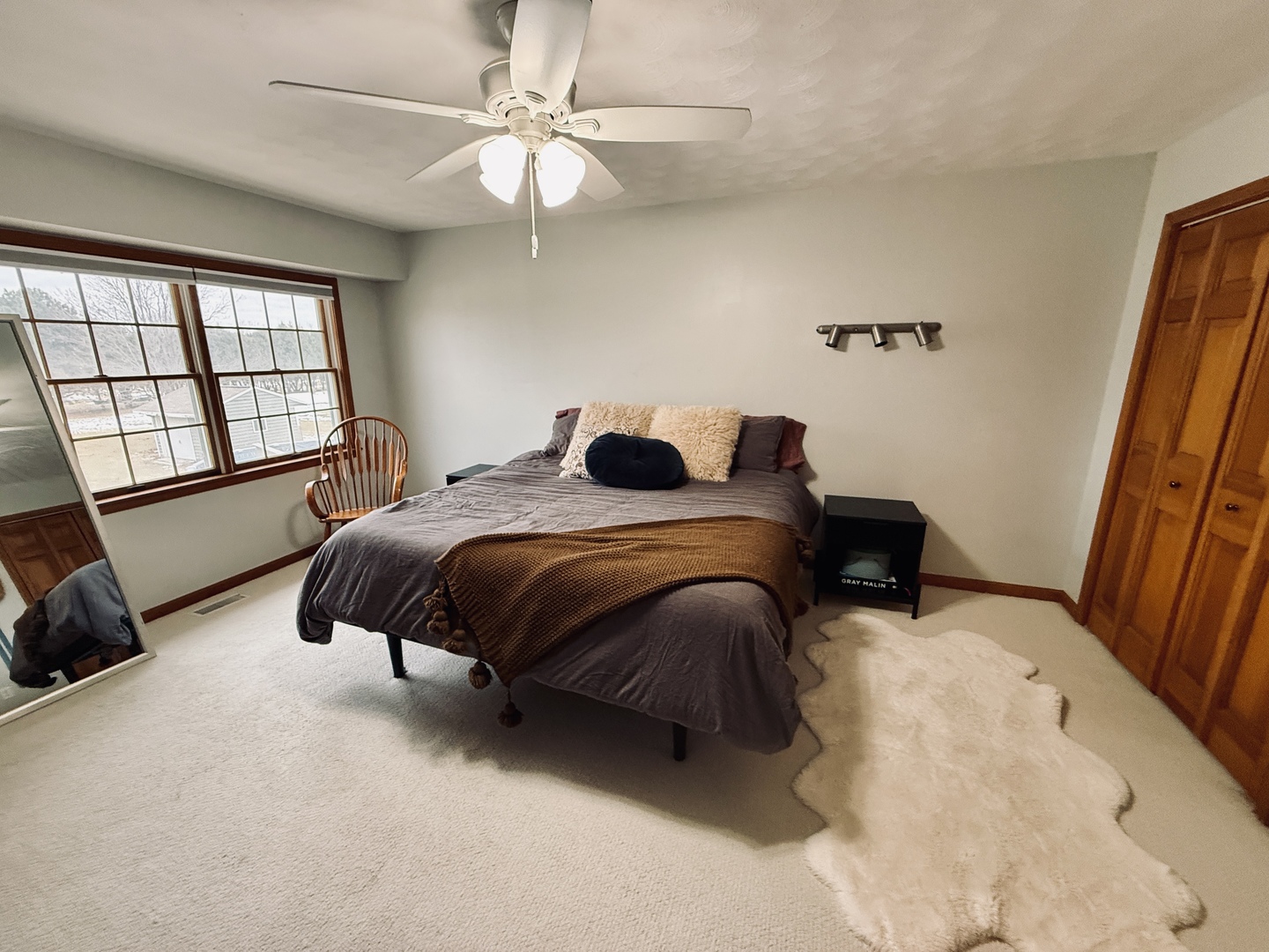 10151 East Hickory Ridge Drive Rochelle, IL 61068 - Photo 15 of 31 a bedroom with a bed a couch and a large window