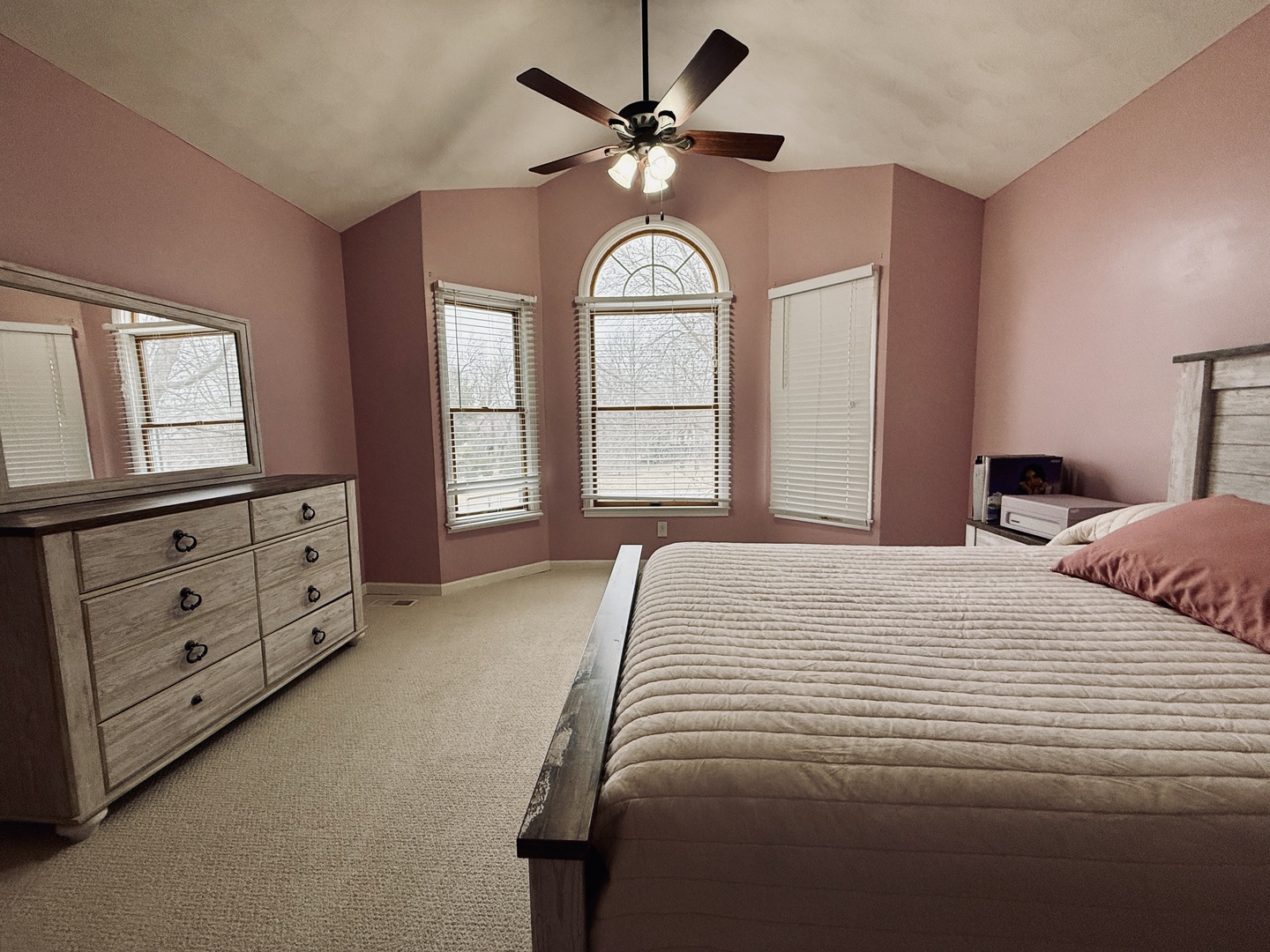 10151 East Hickory Ridge Drive Rochelle, IL 61068 - Photo 20 of 31 a bedroom with a large bed and a chandelier