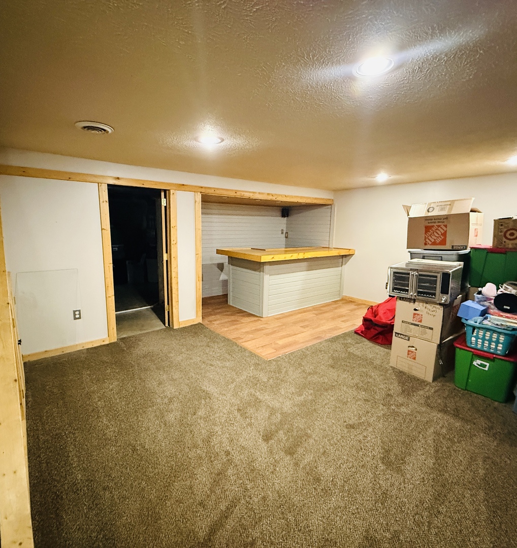 10151 East Hickory Ridge Drive Rochelle, IL 61068 - Photo 27 of 31 a bedroom with furniture and a flat screen tv