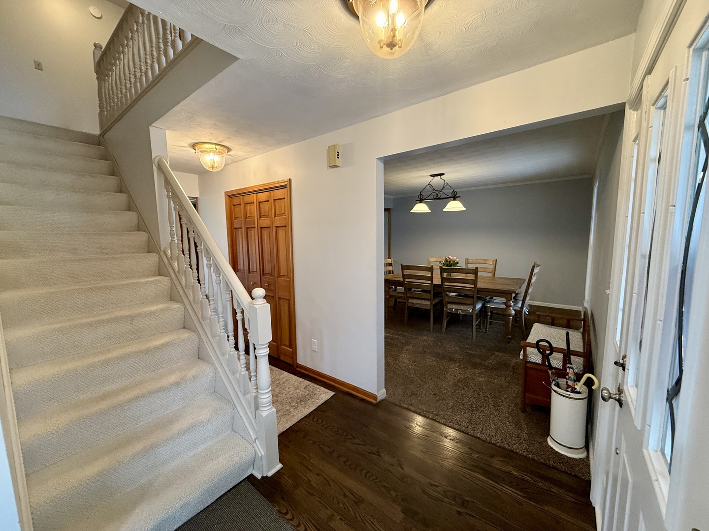 10151 East Hickory Ridge Drive Rochelle, IL 61068 - Photo 4 of 31 a view of a livingroom with wooden floor and stairs