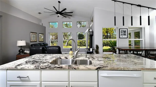 a kitchen with cabinets and chairs