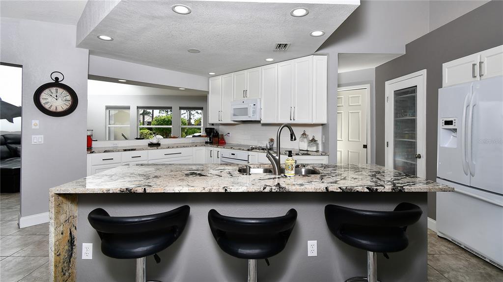 5010 Sable Key Circle Punta Gorda, FL 33955 - Photo 17 of 41 a kitchen with cabinets and chairs