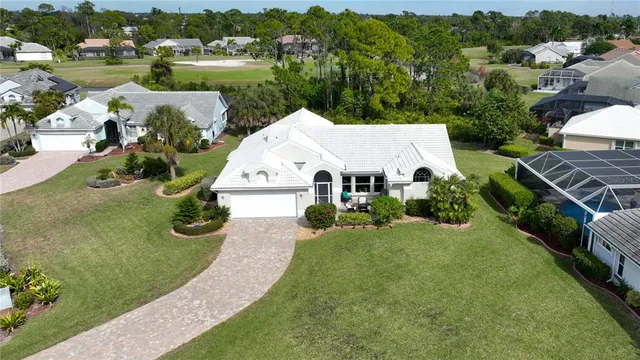 an aerial view of a house with garden space and street view