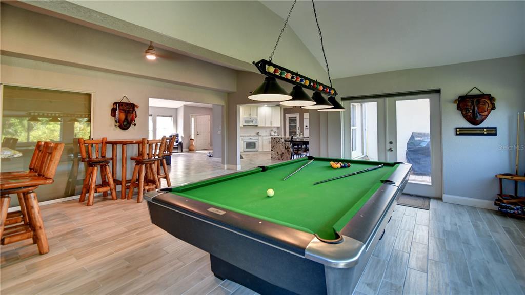 5010 Sable Key Circle Punta Gorda, FL 33955 - Photo 21 of 41 a room with pool table windows and wooden floor