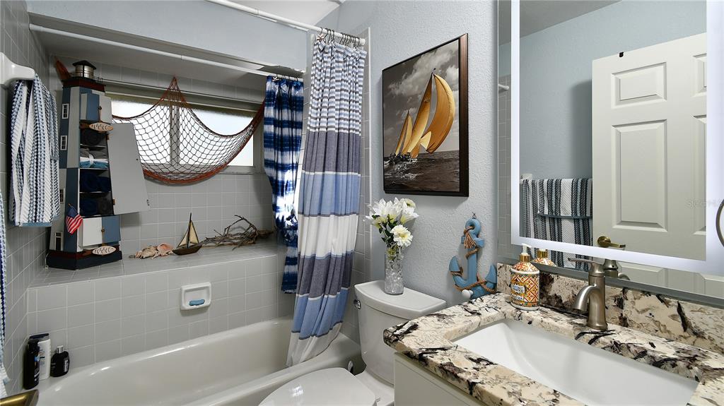 5010 Sable Key Circle Punta Gorda, FL 33955 - Photo 25 of 41 a bathroom with a sink a toilet and a mirror