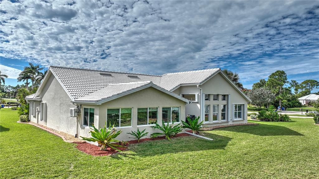 5010 Sable Key Circle Punta Gorda, FL 33955 - Photo 36 of 41 a front view of a house with a yard and potted plants