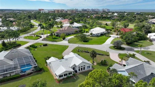 an aerial view of a house with a garden and mountain view in back