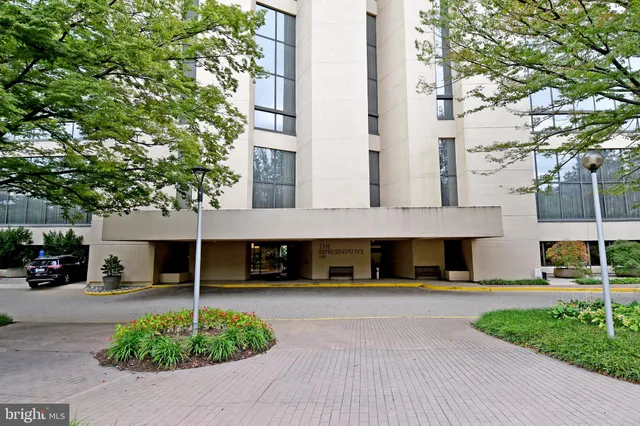 a front view of a building with a garden
