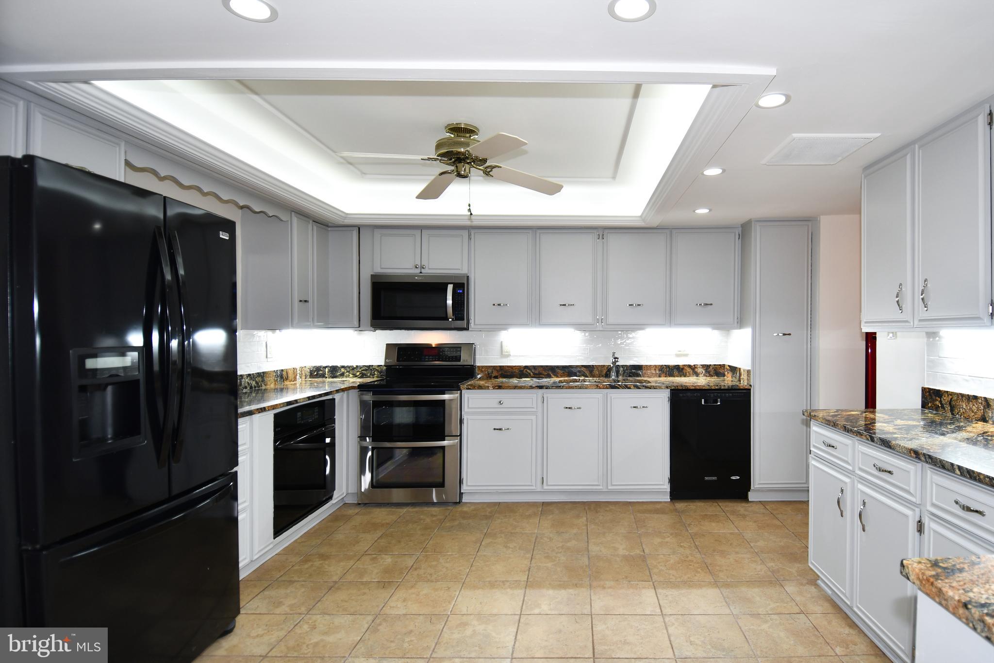 1101 South Arlington Ridge Road, Unit 316 Arlington, VA 22202 - Photo 19 of 75 a large kitchen with cabinets and stainless steel appliances
