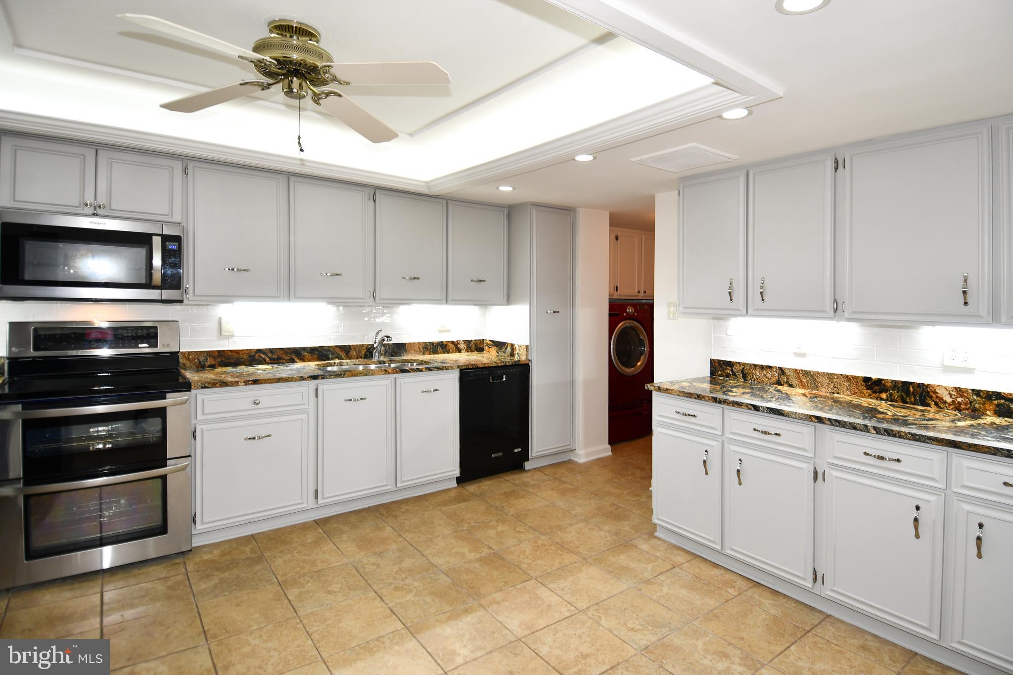 1101 South Arlington Ridge Road, Unit 316 Arlington, VA 22202 - Photo 21 of 75 a kitchen with stainless steel appliances granite countertop a stove sink and cabinets