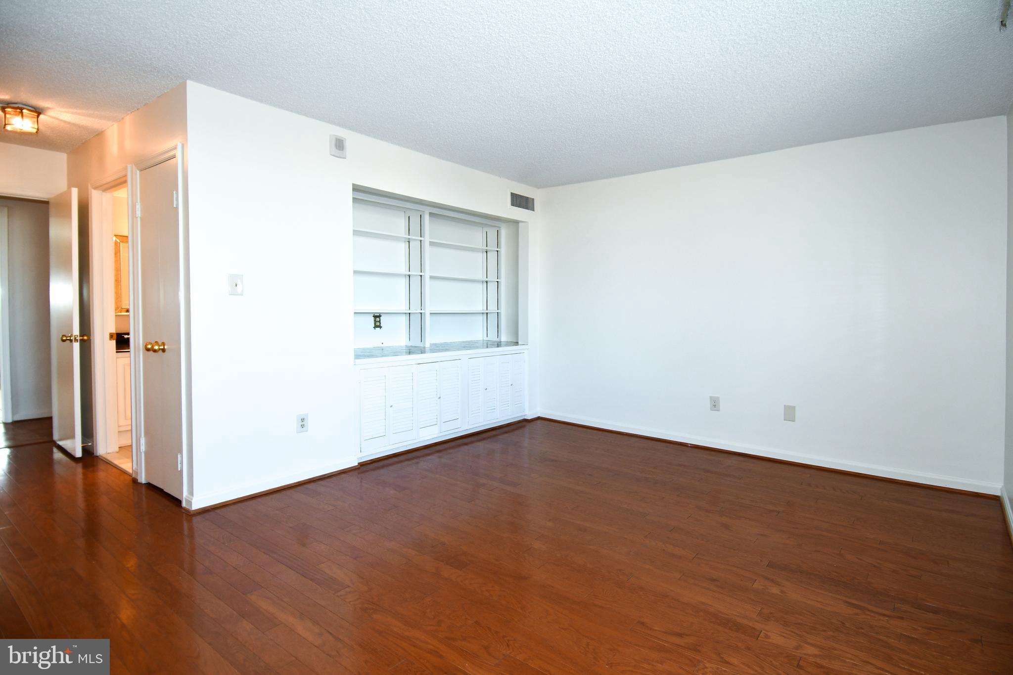 1101 South Arlington Ridge Road, Unit 316 Arlington, VA 22202 - Photo 27 of 75 an empty room with wooden floor and windows