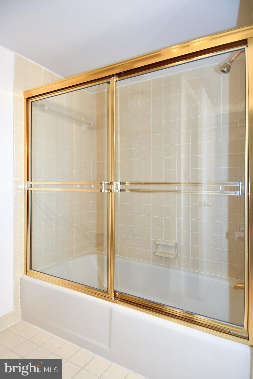 1101 South Arlington Ridge Road, Unit 316 Arlington, VA 22202 - Photo 50 of 75 a bathroom with a shower and a glass door