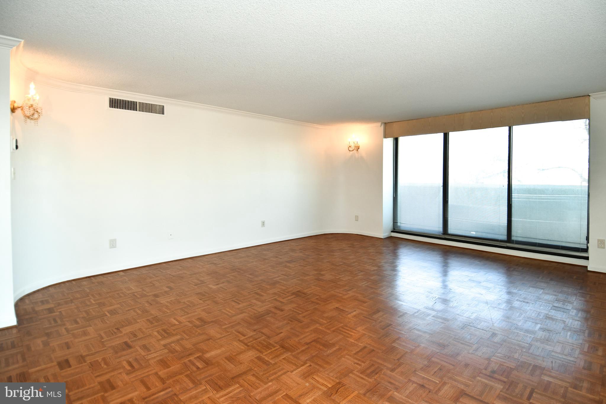 1101 South Arlington Ridge Road, Unit 316 Arlington, VA 22202 - Photo 59 of 75 an empty room with wooden floor and windows