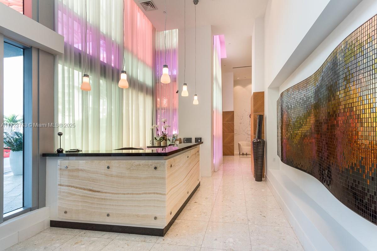 3801 Collins Avenue, Unit TH4 Miami Beach, FL 33140 - Photo 18 of 19 a bathroom with a sink a mirror and a shower