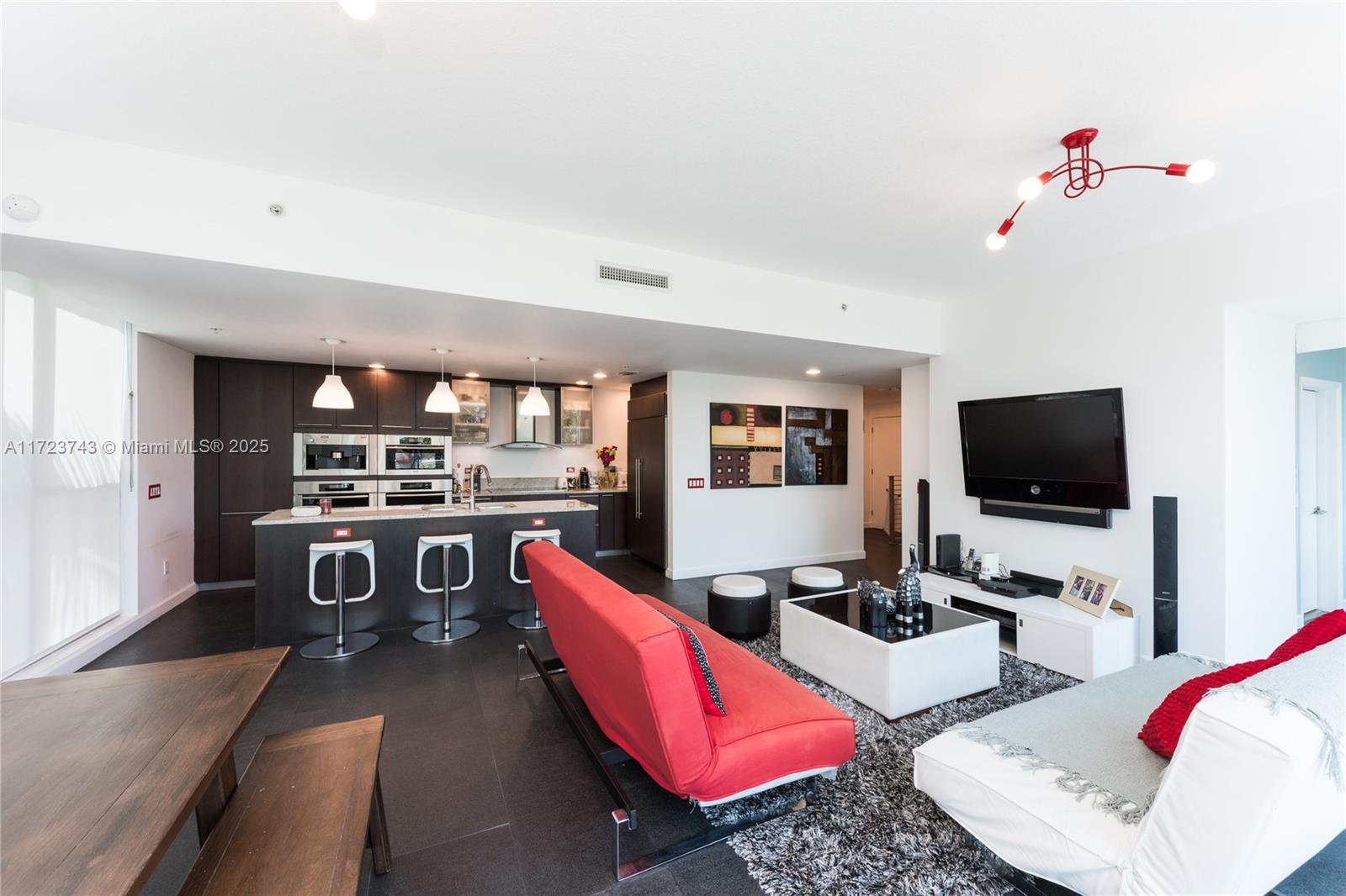 3801 Collins Avenue, Unit TH4 Miami Beach, FL 33140 - Photo 6 of 19 a living room with furniture and a flat screen tv