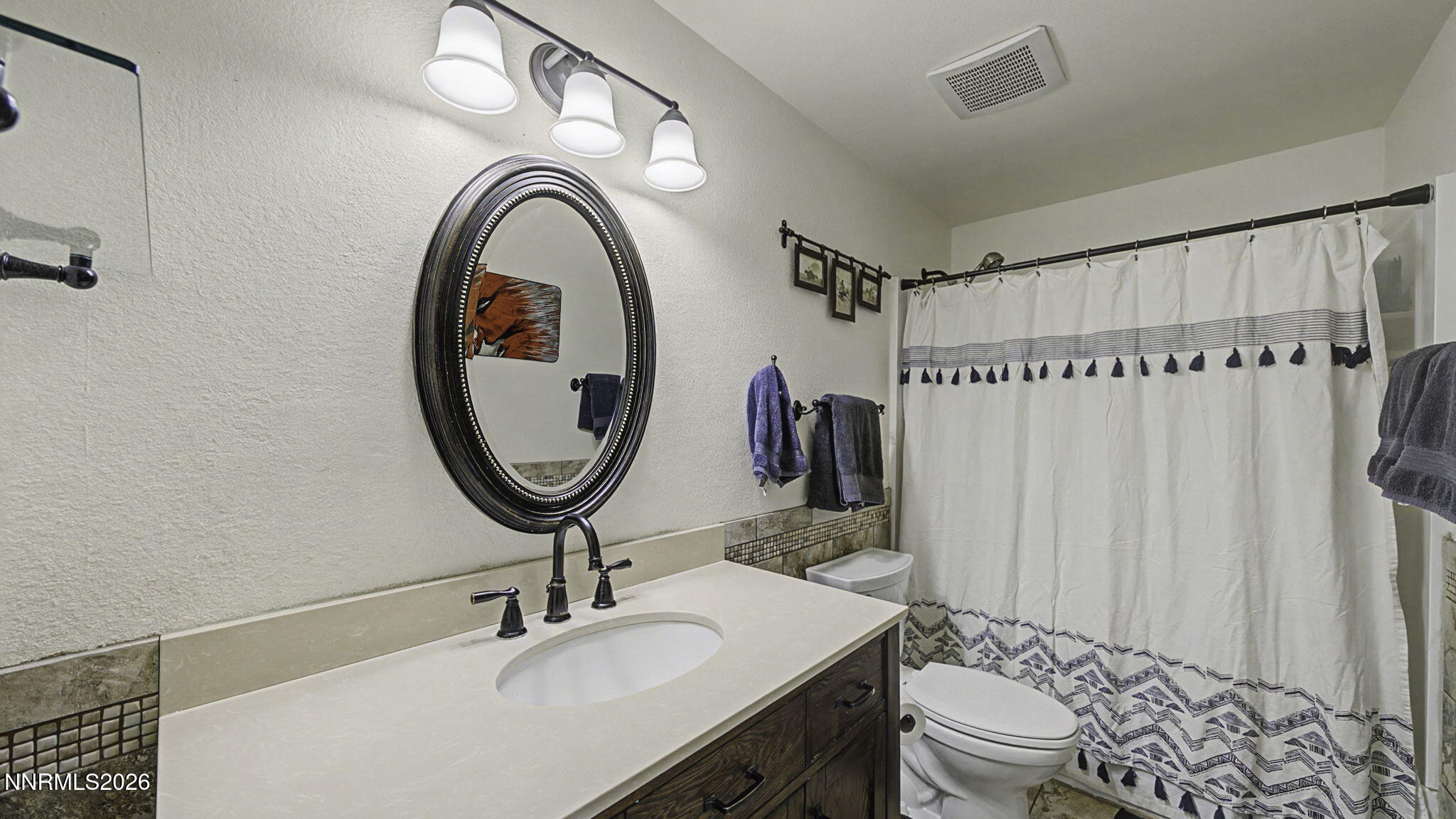 10585 Silver Knolls Boulevard Reno, NV 89508 - Photo 28 of 50 a bathroom with a sink a toilet and a mirror
