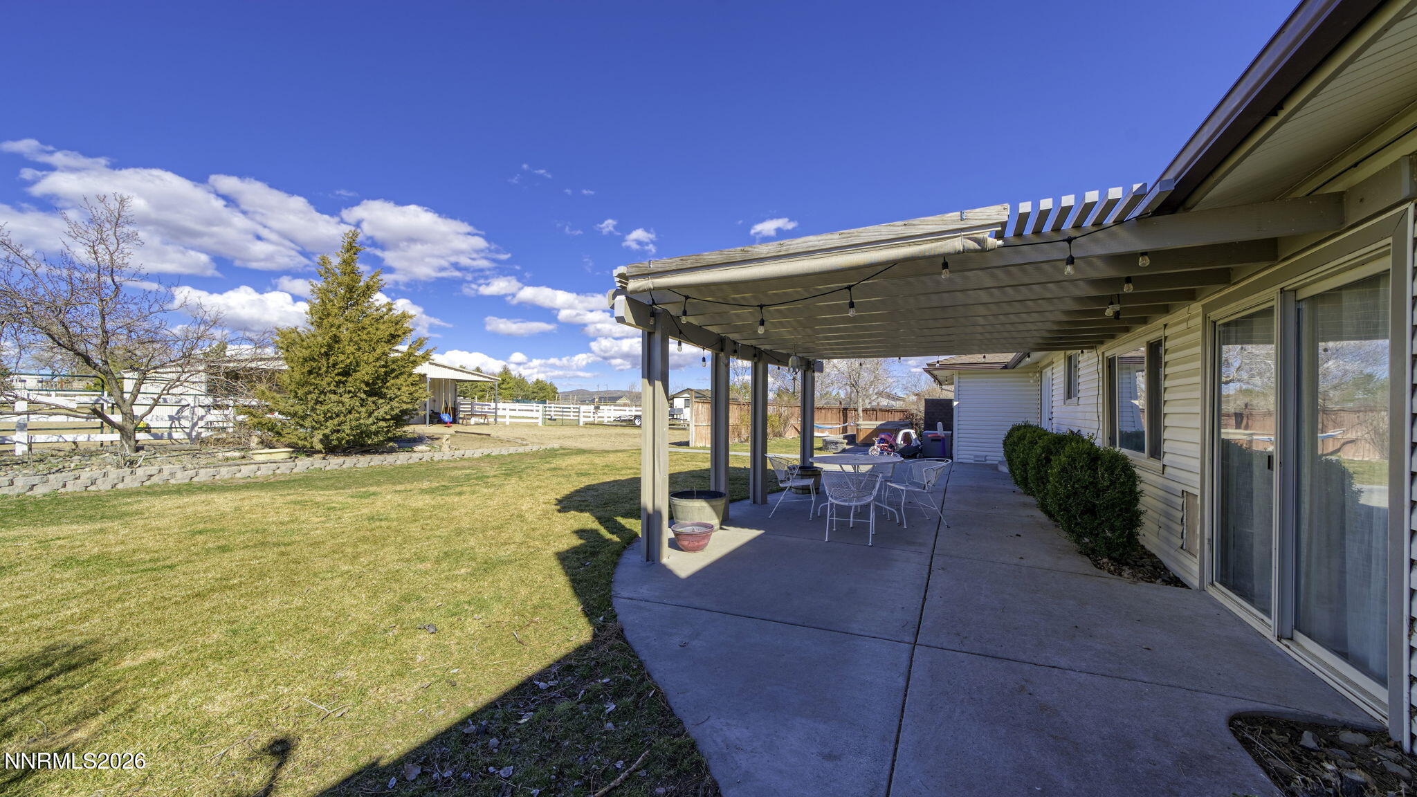10585 Silver Knolls Boulevard Reno, NV 89508 - Photo 40 of 50 a view of a patio with lawn chairs under an umbrella
