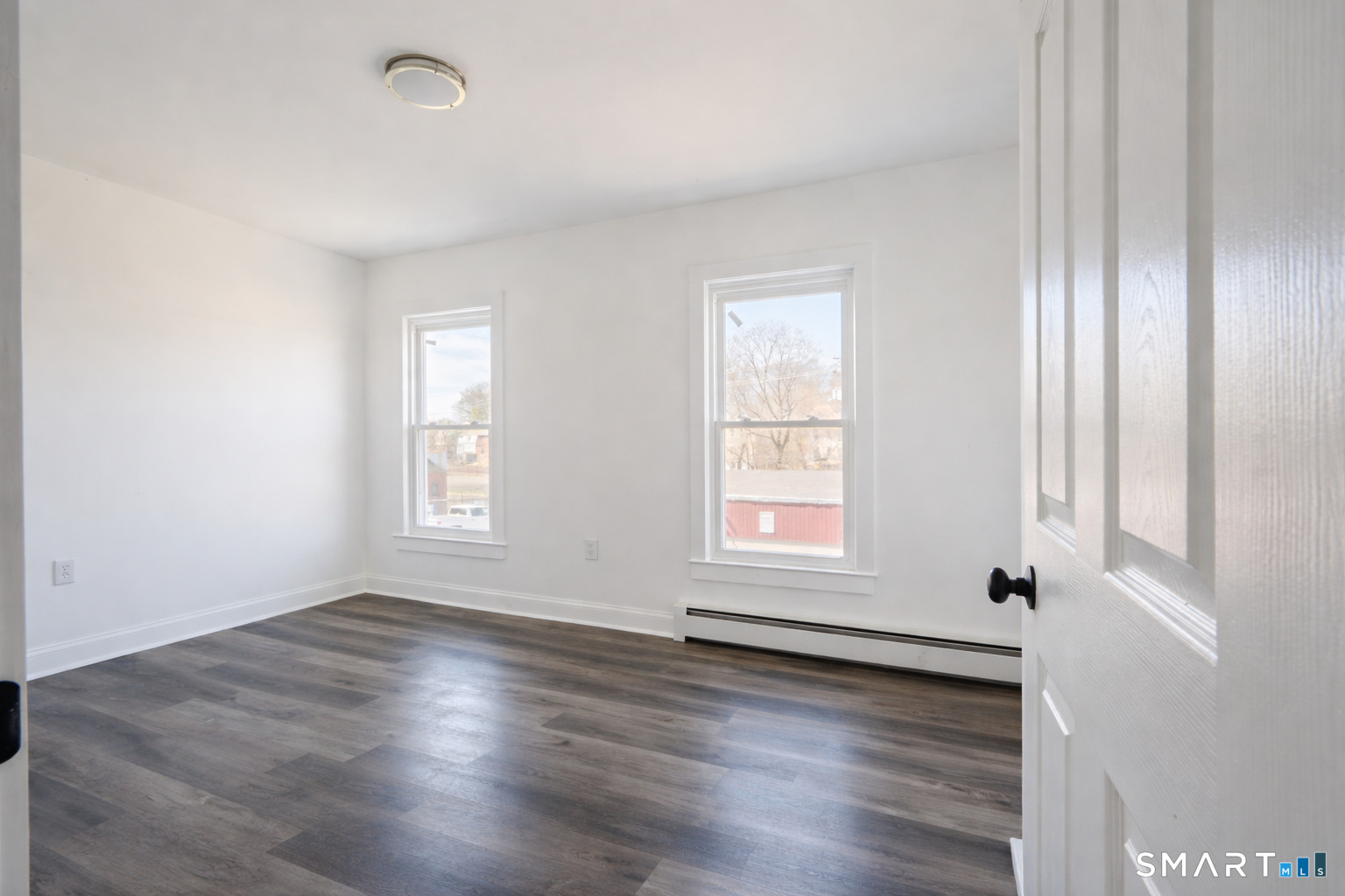 17 Sherman Avenue, Unit 3 Meriden, CT 06450 - Photo 11 of 19 an empty room with wooden floor and windows