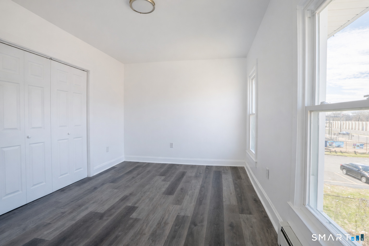 17 Sherman Avenue, Unit 3 Meriden, CT 06450 - Photo 12 of 19 an empty room with wooden floor and windows