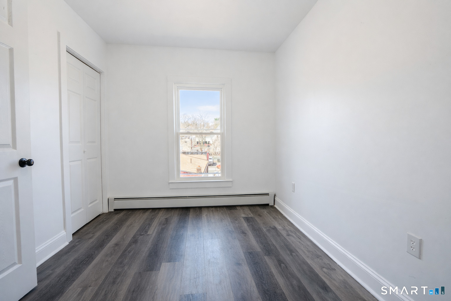 17 Sherman Avenue, Unit 3 Meriden, CT 06450 - Photo 15 of 19 an empty room with wooden floor and windows