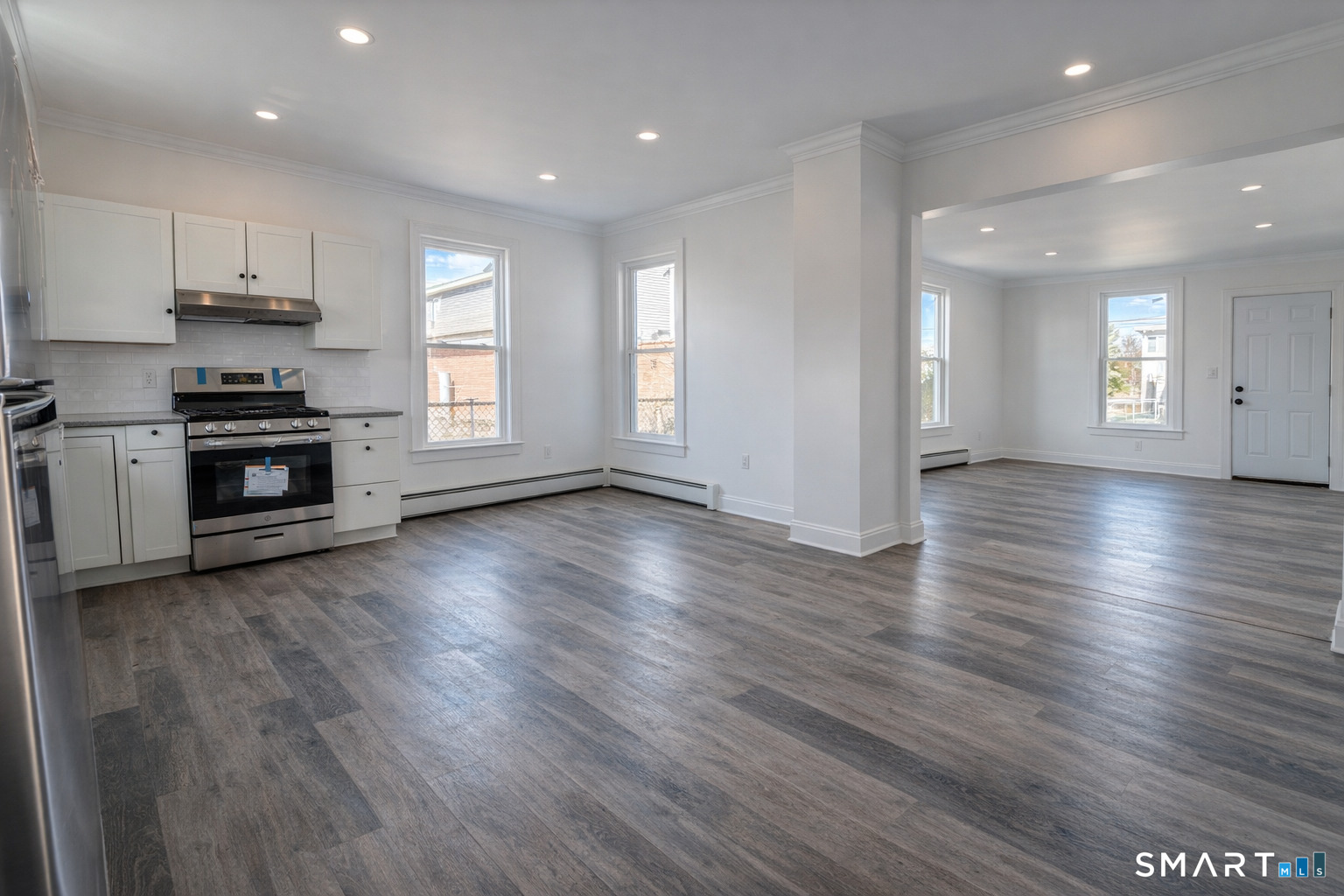17 Sherman Avenue, Unit 3 Meriden, CT 06450 - Photo 17 of 19 an empty room with wooden floor and stainless steel appliances