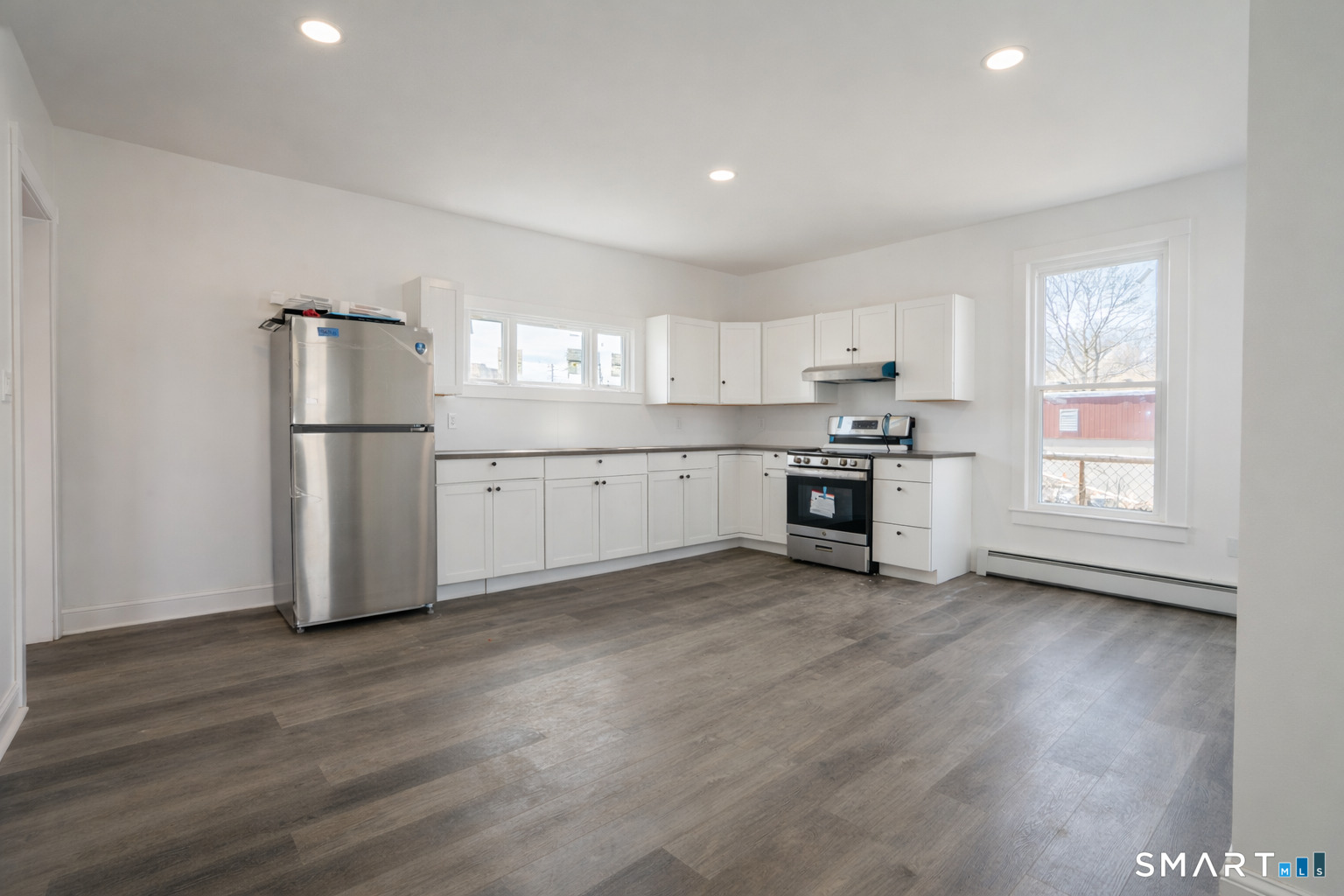 17 Sherman Avenue, Unit 3 Meriden, CT 06450 - Photo 2 of 19 a kitchen with granite countertop white cabinets and stainless steel appliances