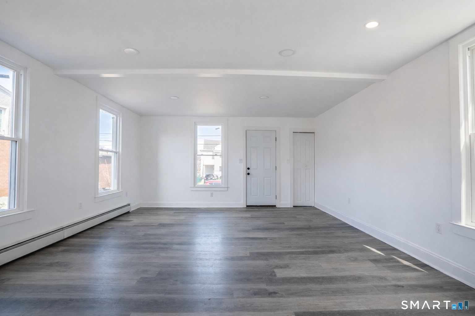 17 Sherman Avenue, Unit 3 Meriden, CT 06450 - Photo 5 of 19 an empty room with wooden floor and windows