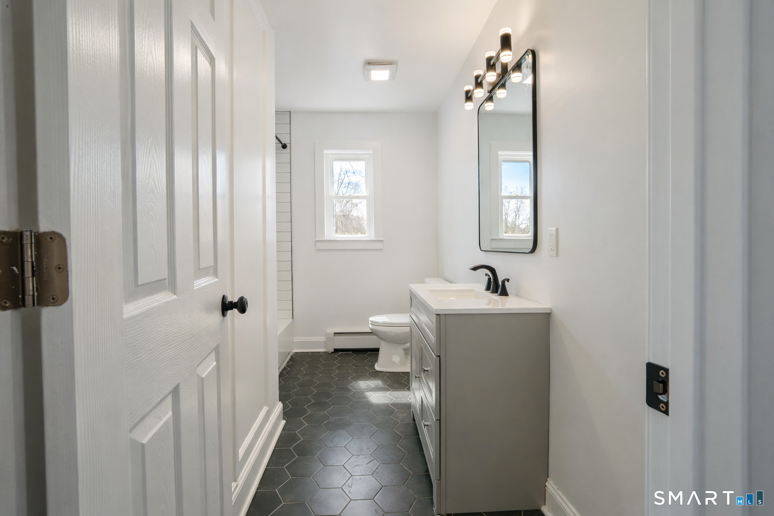 17 Sherman Avenue, Unit 3 Meriden, CT 06450 - Photo 8 of 19 a bathroom with a sink and mirror with shower