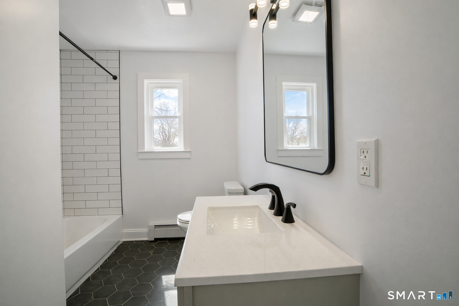 17 Sherman Avenue, Unit 3 Meriden, CT 06450 - Photo 9 of 19 a bathroom with a sink a toilet and window