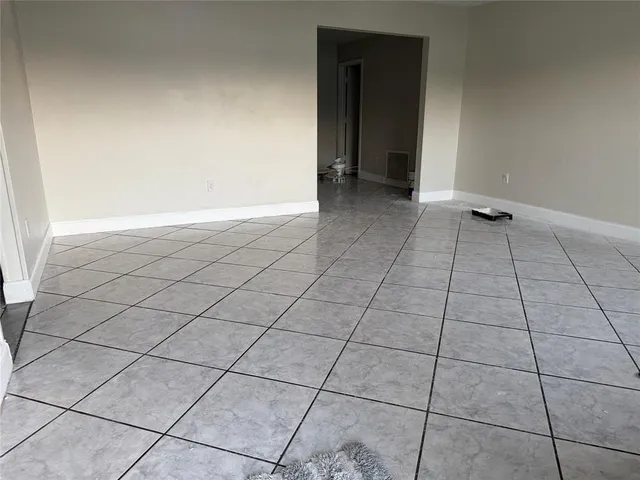 a view of an empty room and entryway