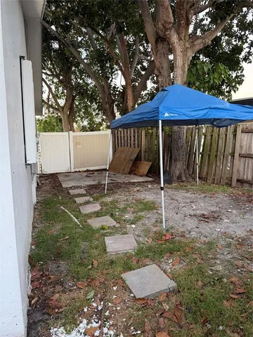 a backyard of a house with barbeque oven