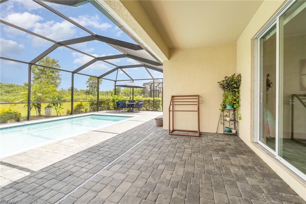 2276 Dancy Street Naples, FL 34120 - Photo 36 of 47 View of swimming pool with a patio and glass enclosure