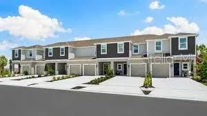 a front view of a building with a garden