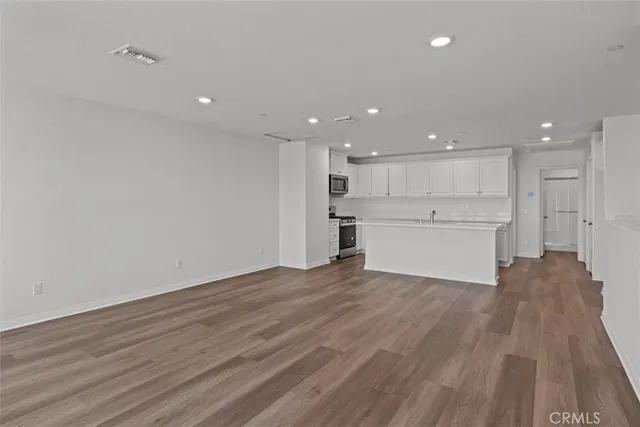 a view of a kitchen with a sink and a refrigerator