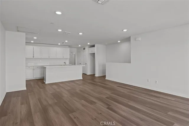 a view of a kitchen with a sink and a refrigerator