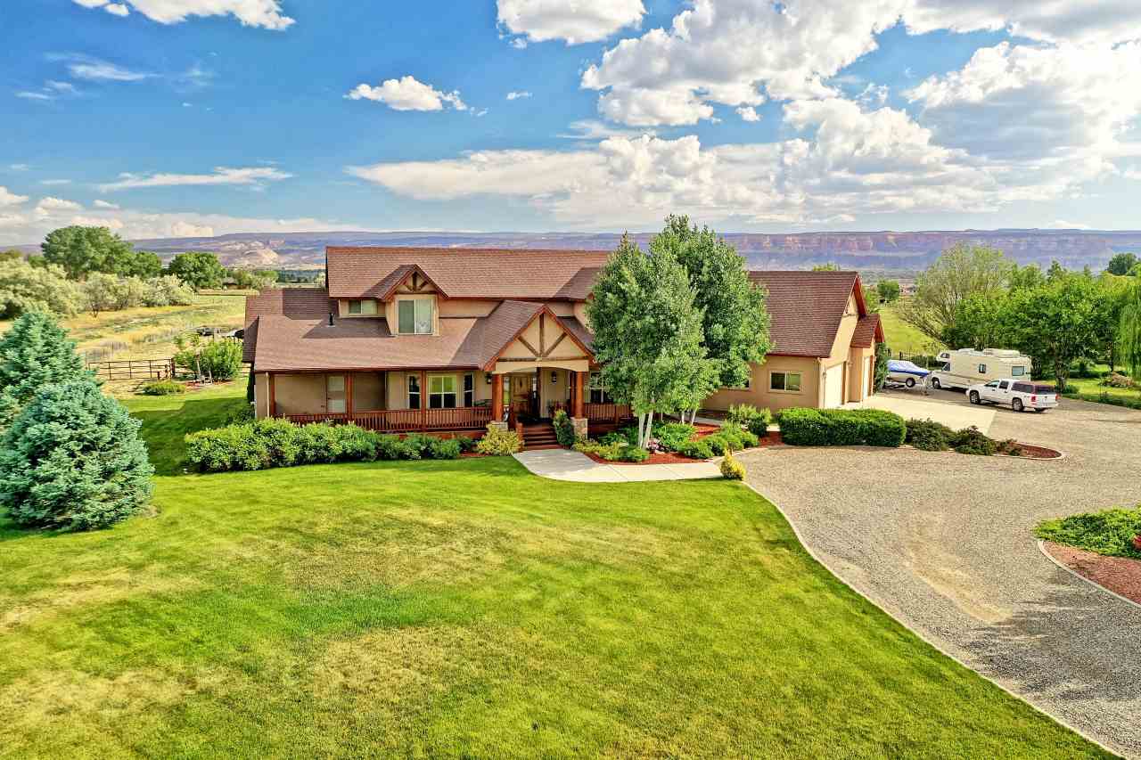 2325 I Road Grand Junction, CO 81505 - Photo 6 of 9 a view of a big house with a big yard and large trees
