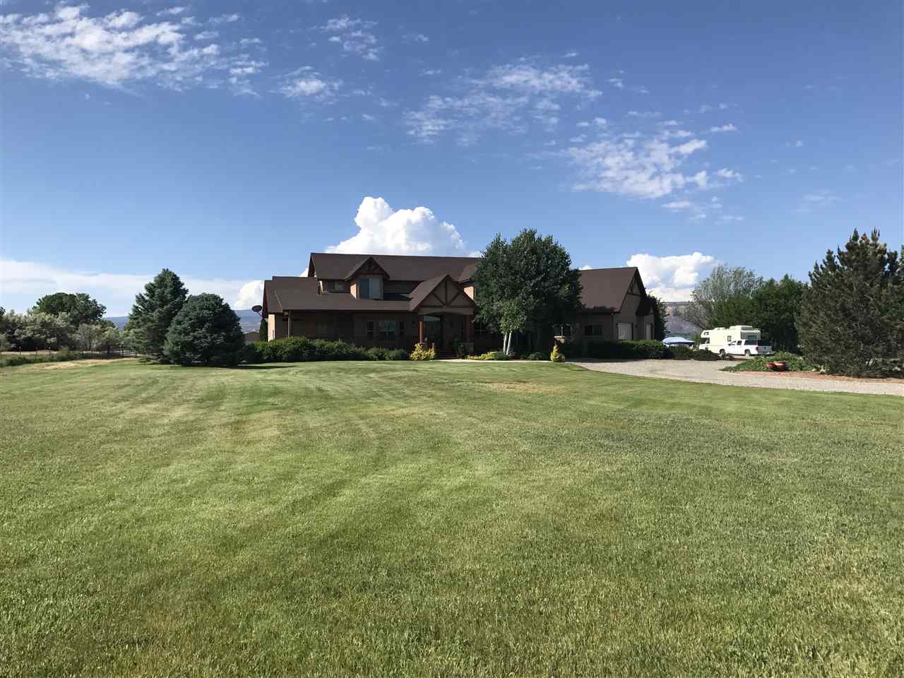 2325 I Road Grand Junction, CO 81505 - Photo 7 of 9 a backyard of a house with table and chairs