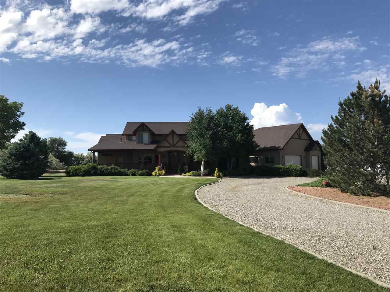 2325 I Road Grand Junction, CO 81505 - Photo 9 of 9 a front view of a house with a garden and yard
