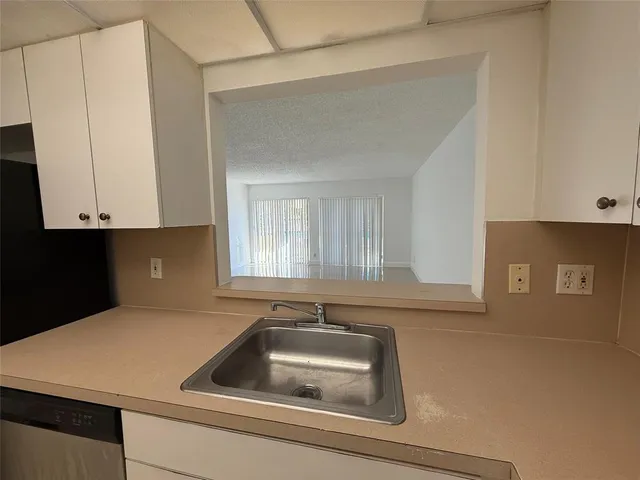 a kitchen with a sink and cabinets