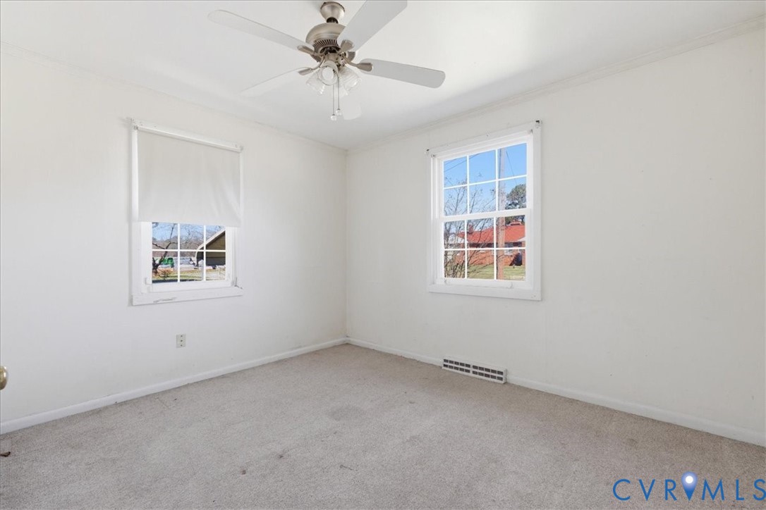 524 Clay Street Wakefield, VA 23888 - Photo 15 of 20 an empty room with windows and fan