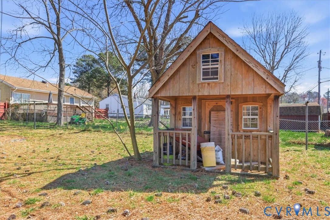 524 Clay Street Wakefield, VA 23888 - Photo 19 of 20 a front view of a house with garden