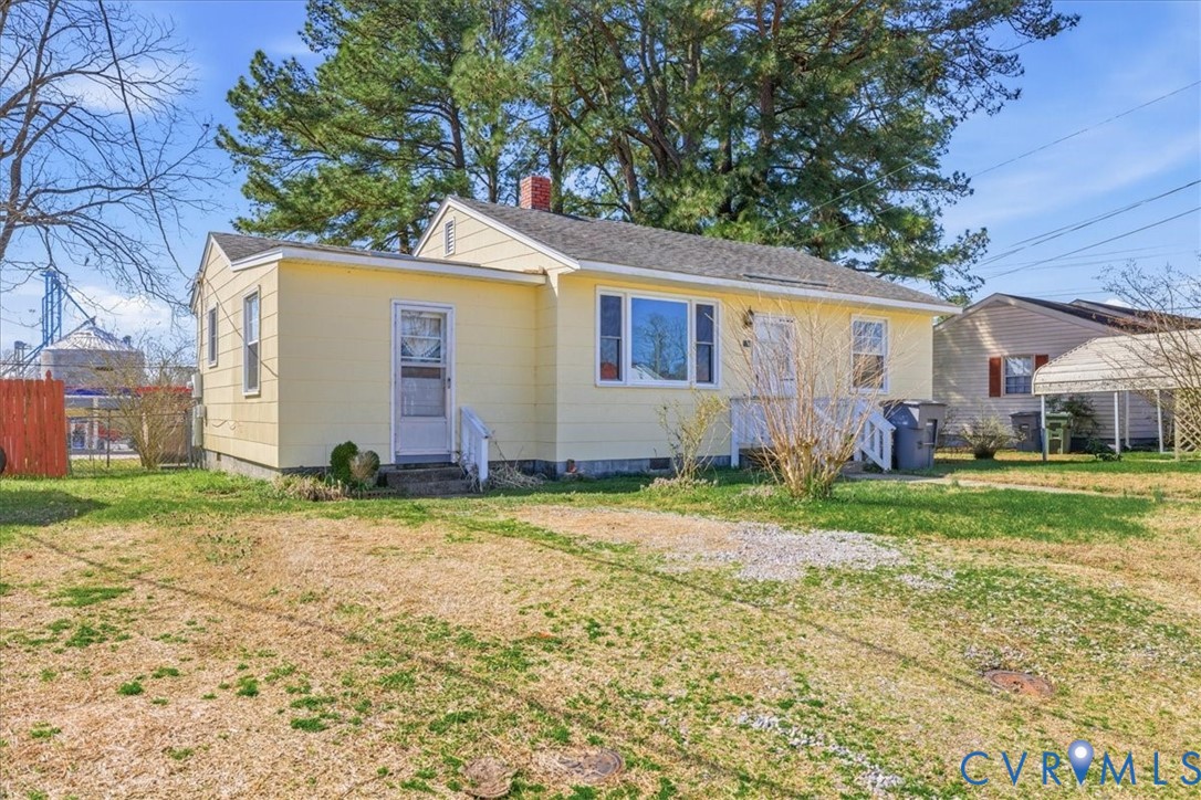 524 Clay Street Wakefield, VA 23888 - Photo 2 of 20 a backyard of a house with barbeque oven table and chairs