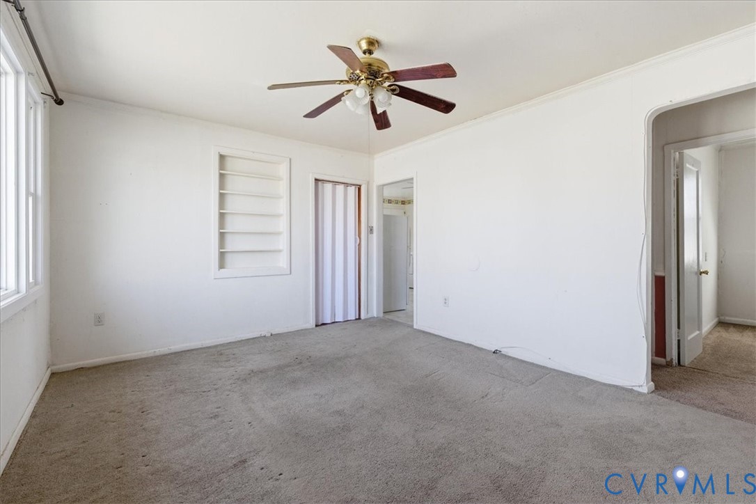 524 Clay Street Wakefield, VA 23888 - Photo 4 of 20 an empty room with windows and fan