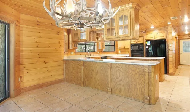 a kitchen with stainless steel appliances granite countertop a sink a counter space and a window