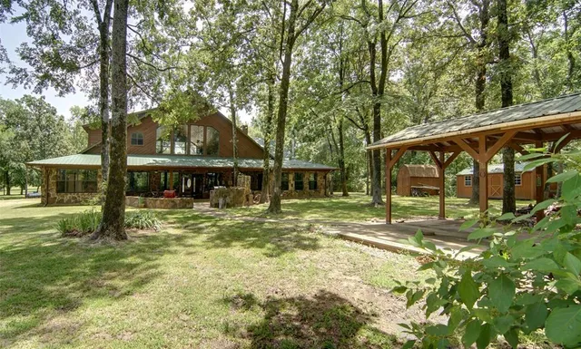 a view of a house with a large window and wooden fence