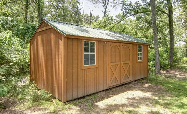 a view of a backyard with large trees
