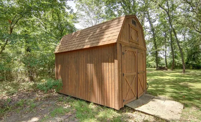 a aerial view of a house with a yard and lake view