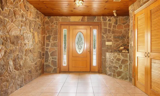a view of a livingroom with wooden floor and a fireplace